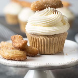 A churro cupcake on a cupcake stand.