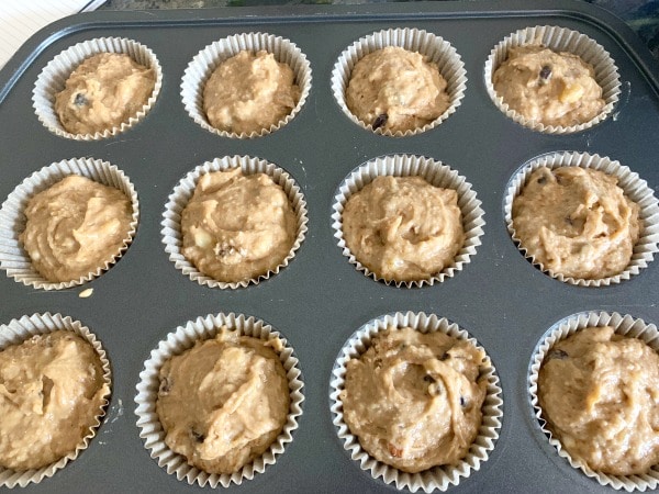 A photo of the muffin batter in a muffin pan ready to bake.