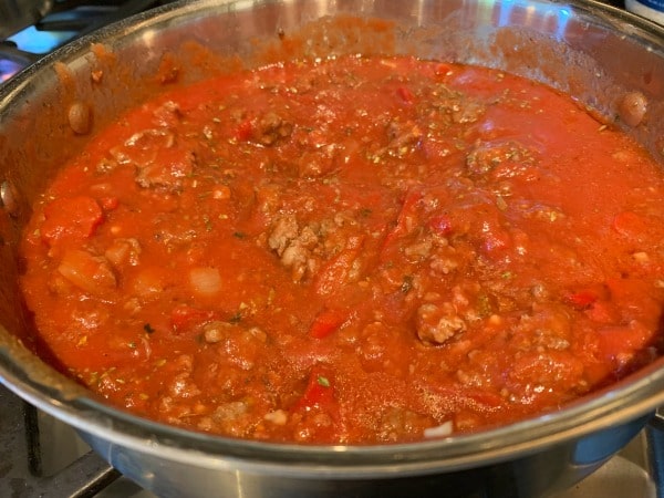 A pot full of pasta meat sauce.