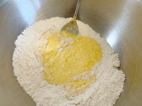 A photo of the wet and dry ingredients in a large mixing bowl.