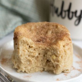 A cooked gluten free snickerdoodle mug cake with a pice cut out.
