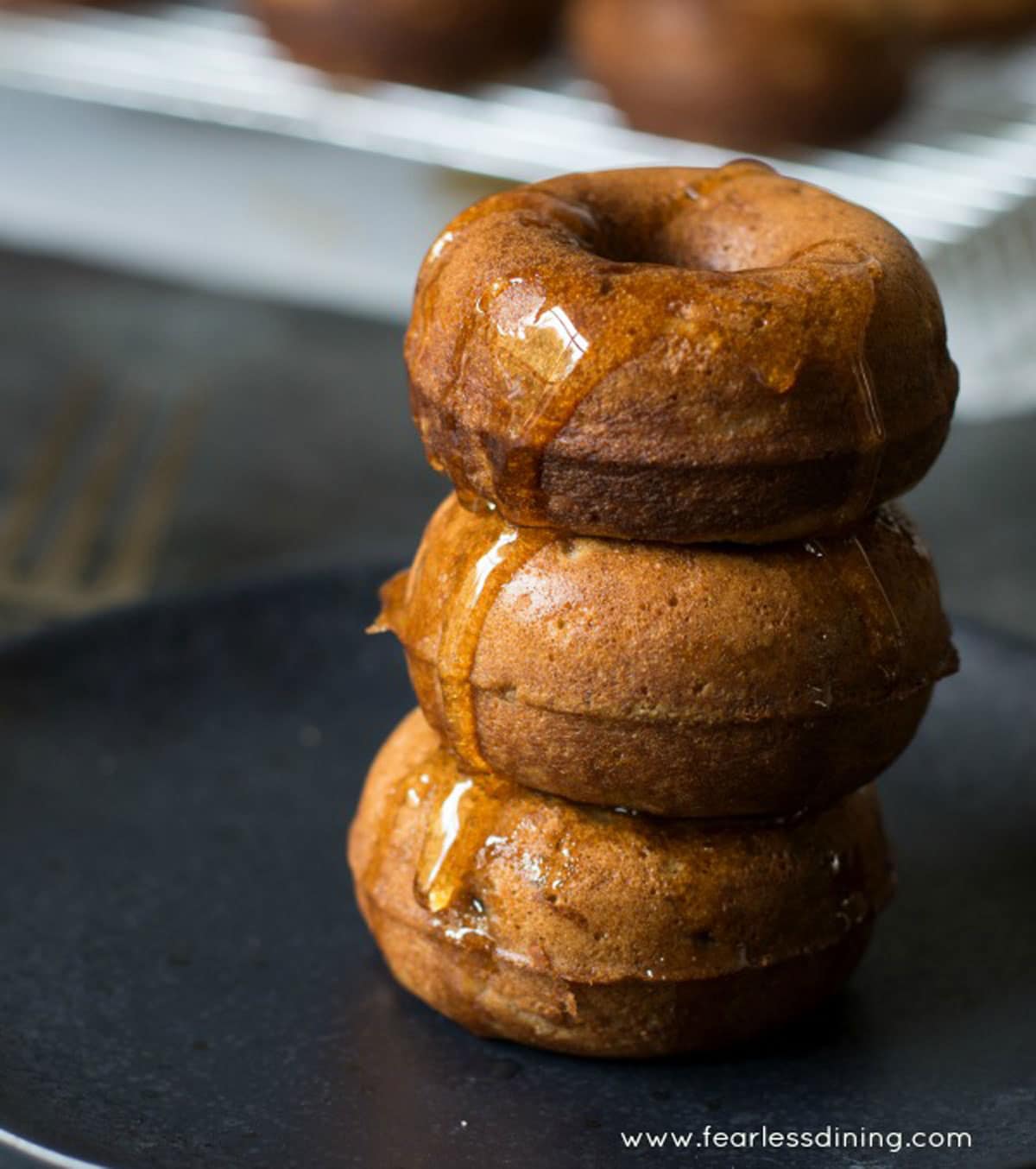 a stack of cinnamon apple donuts on a plate