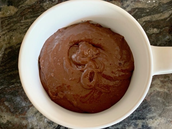 Gluten free chocolate cake batter in a mug ready to microwave.