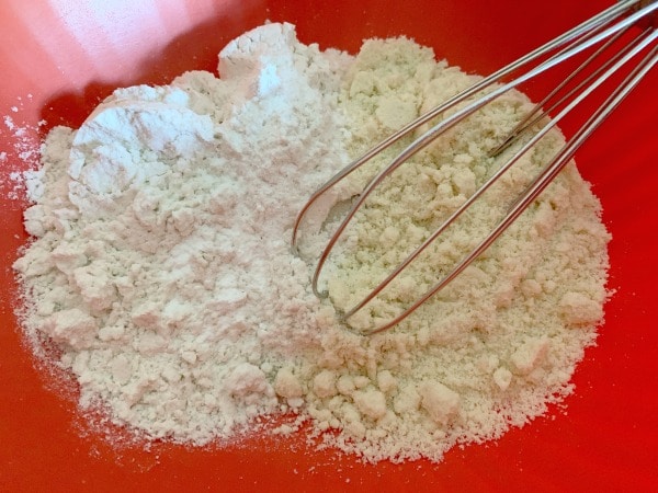 The dry ingredients in a red bowl.