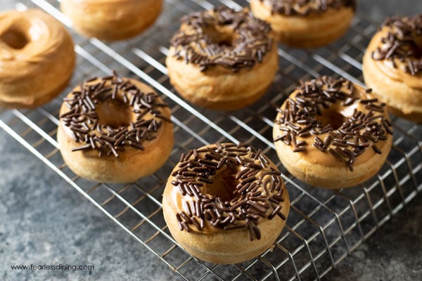 peanut butter donuts with sprinkles on a rack