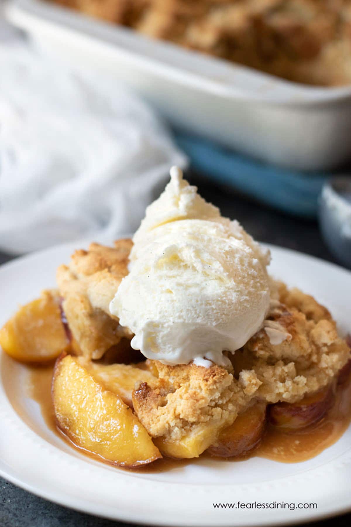 A serving of grain-free peach cobbler with almond flour on a plate.