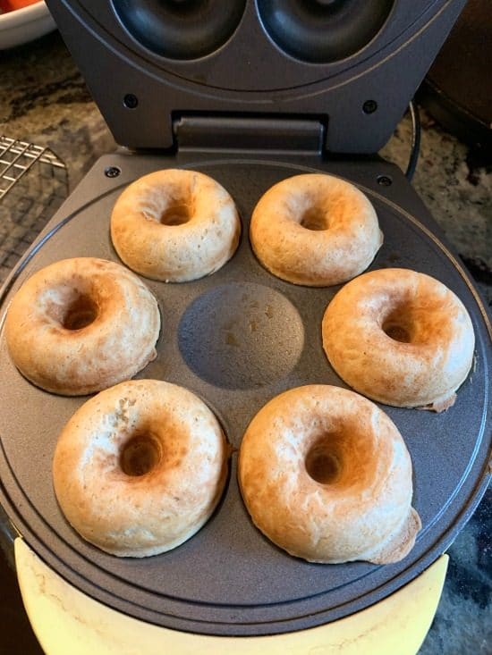 Cooked donuts in a donut maker.