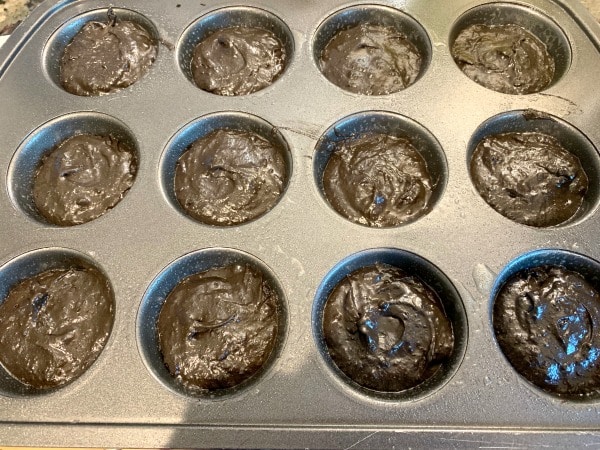 Cupcake batter in a muffin tin.