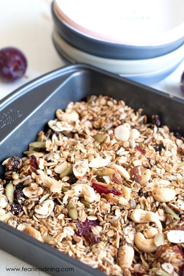 A close up of the granola topped plum crisp in a pan.