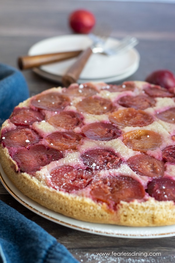 A gluten free plum upside down cake on a plate.