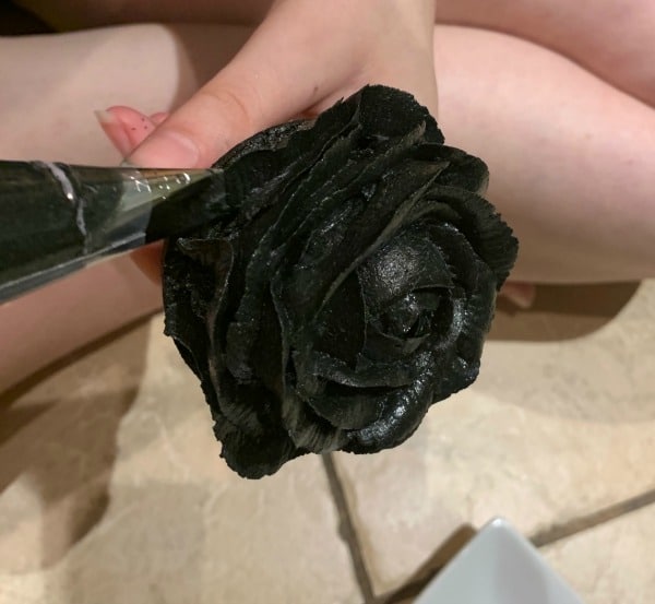 Making black rose petals out of frosting.