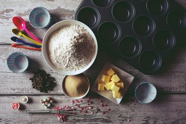 muffin ingredients next to a muffin tin