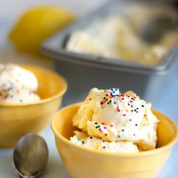 a yellow bowl filled with lemon ice cream. It is topped with rainbow sprinkles