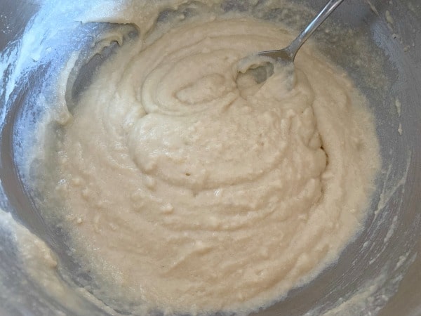 The plum cake batter in a mixing bowl.