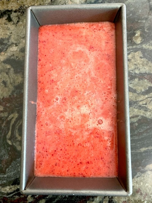 The plum sorbet mixture in a bread tin ready to freeze.