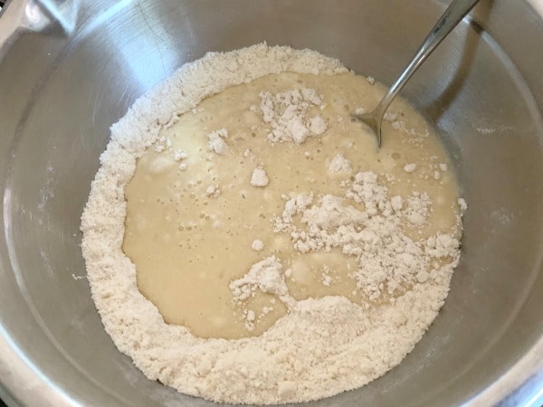 The wet and dry cake ingredients in a bowl.