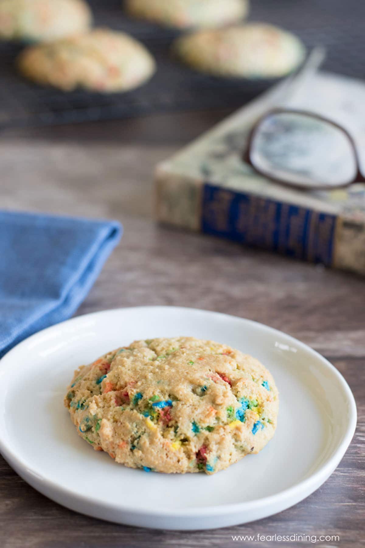 A gluten free funfetti cookie on a small white plate.