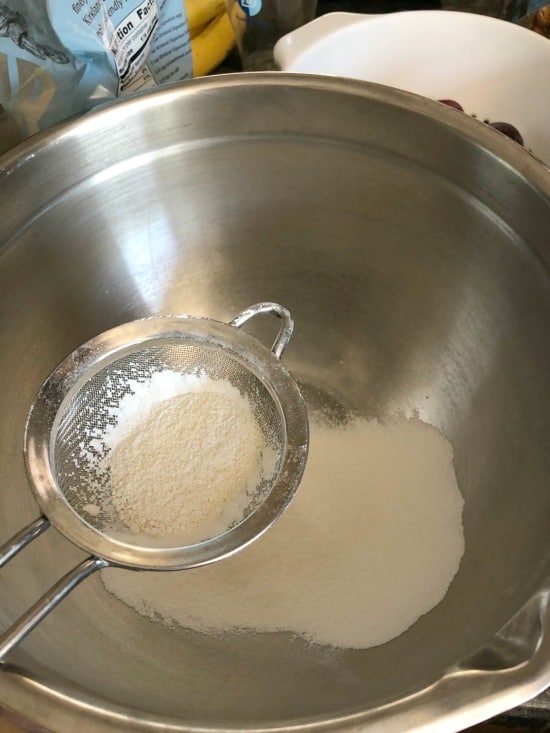sifting powdered sugar and almond flour together