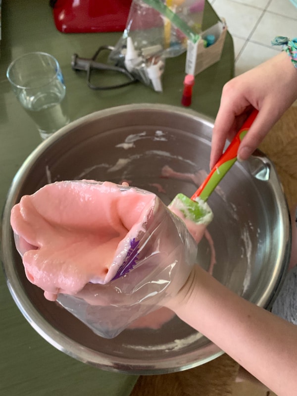 Adding macaron batter to a pastry bag.