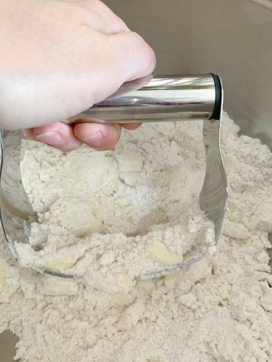 using a pastry blender to cut in the butter