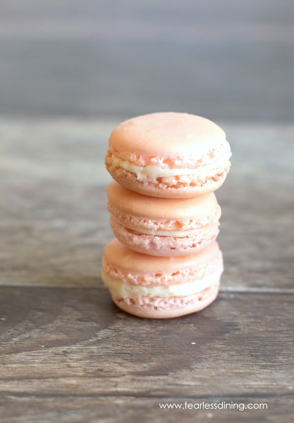 A stack of 3 raspberry macarons.