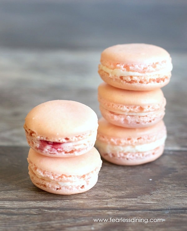 Two stacks of raspberry macarons.