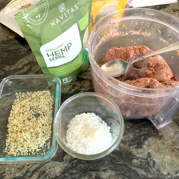containers with hemp seeds and coconut to roll the protein balls in