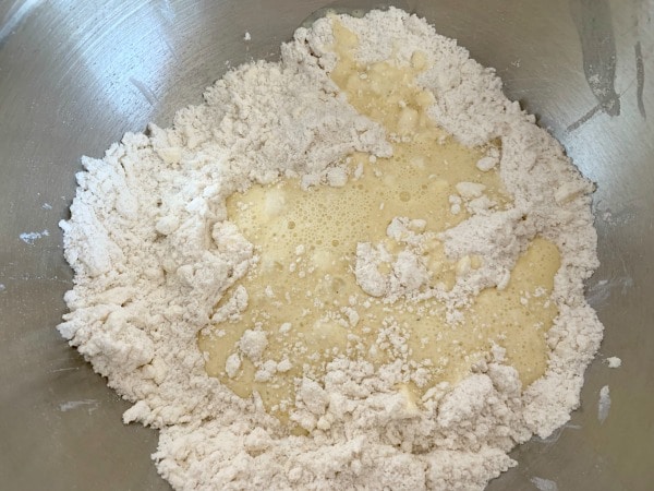 The wet and dry ingredients in a mixing bowl.