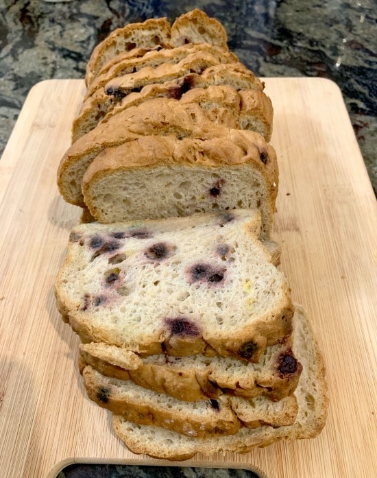 Sliced blueberry bread on a cutting board.