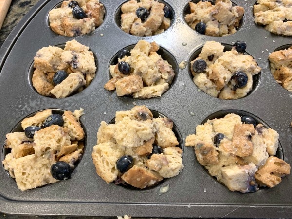 French toast muffins in a muffin tin ready to bake.