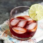 A prickly pear cocktail with bourbon on a napkin.
