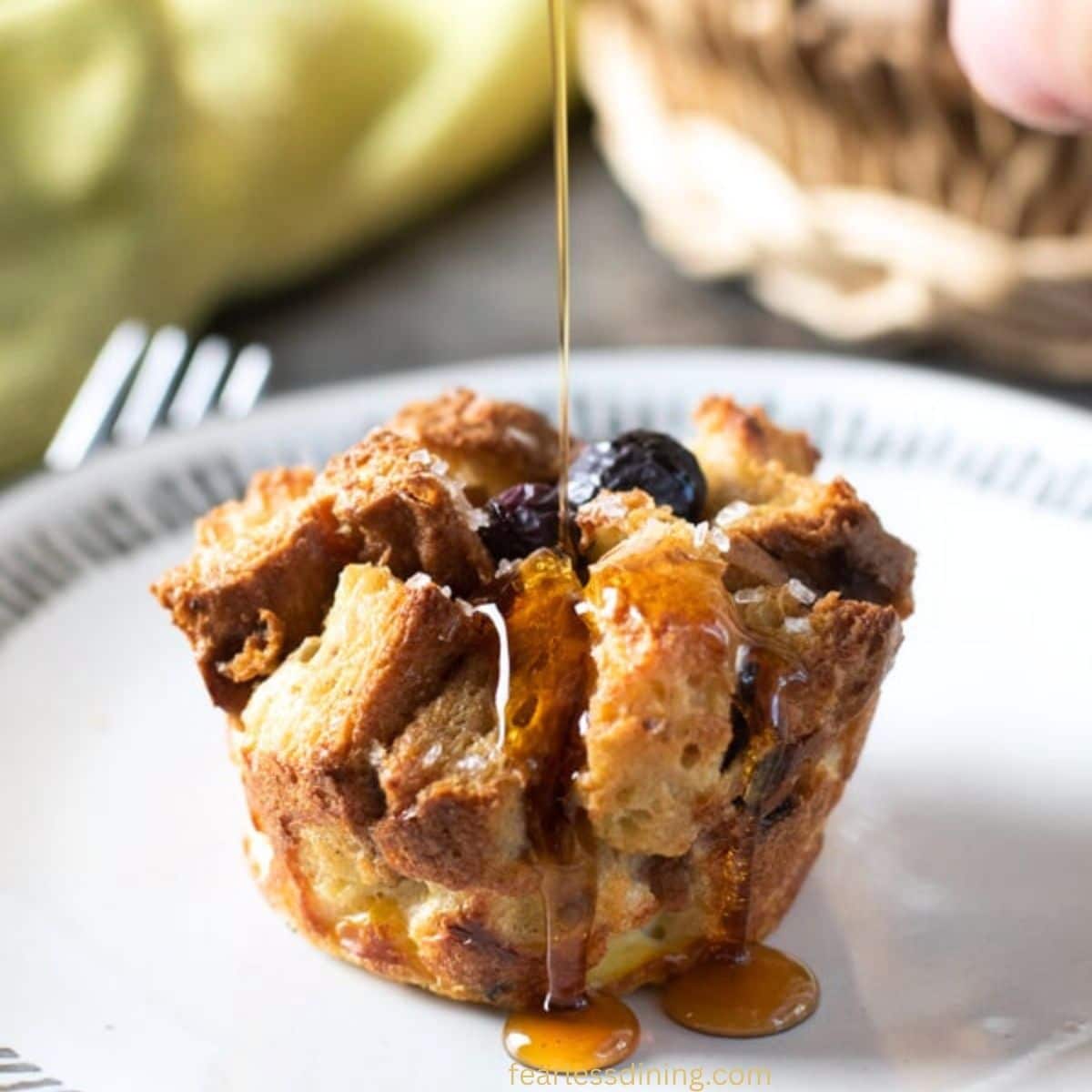 Drizzling syrup over a gluten-free French toast muffin.