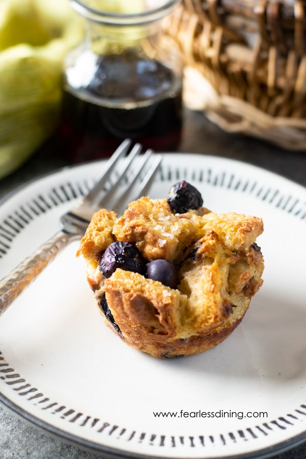 A gluten free French toast muffin with blueberries on a plate.
