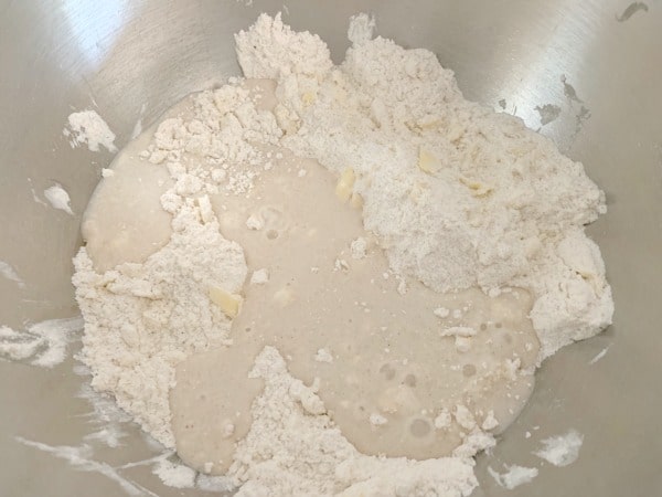 adding the wet ingredients to the bowl of flour