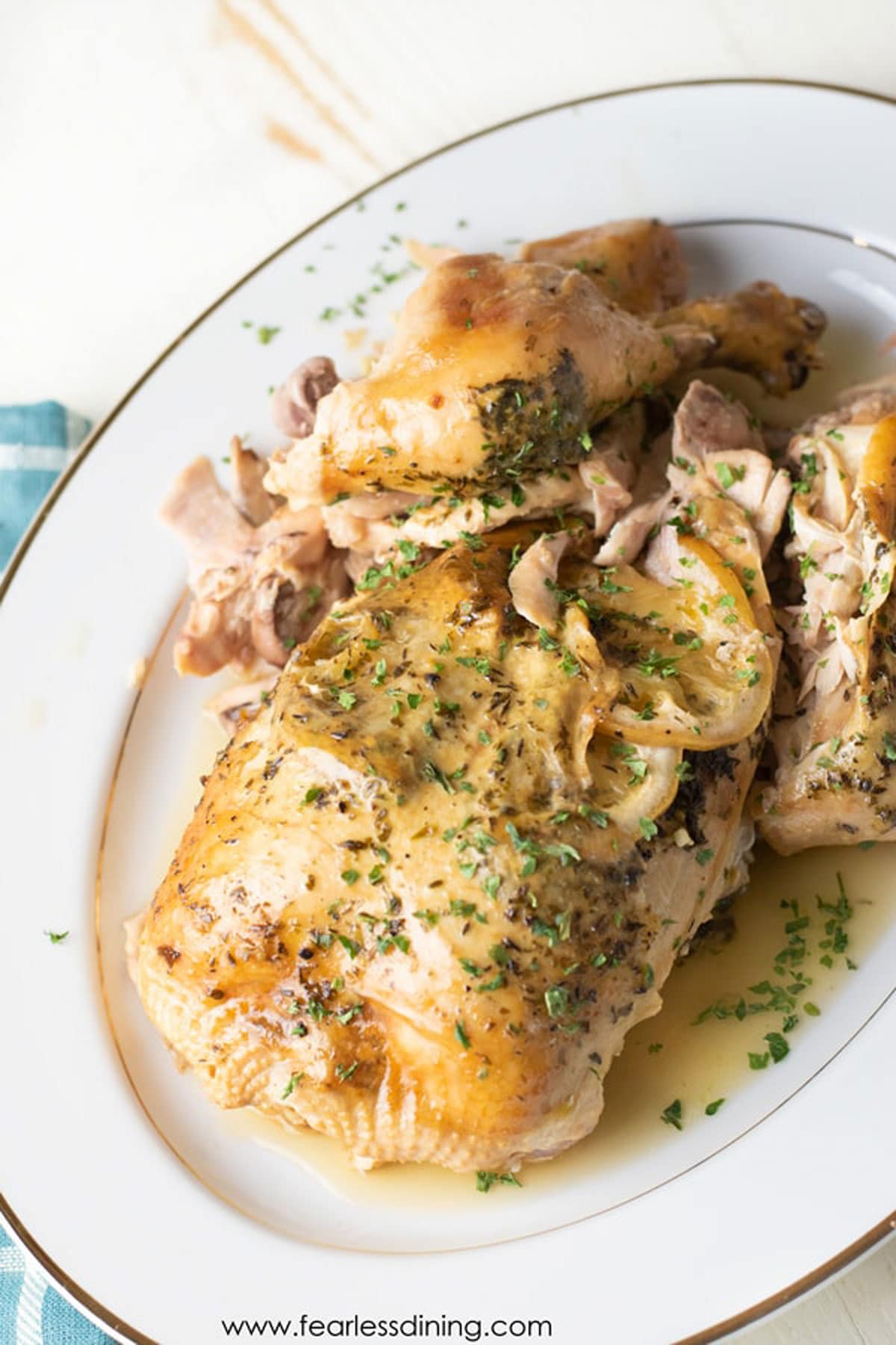 A platter with a whole slow cooker lemon chicken.