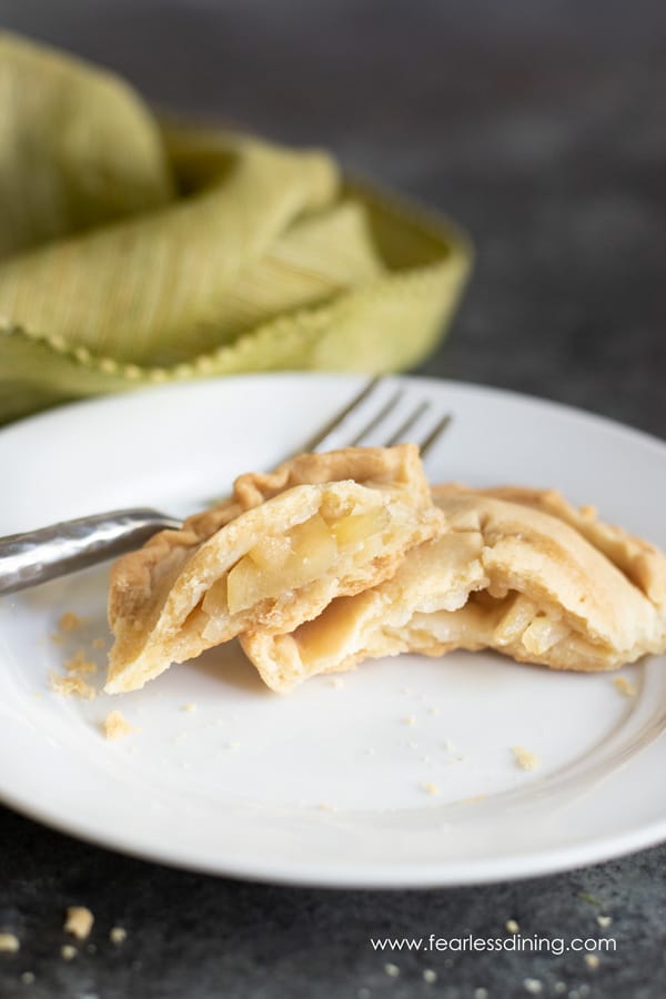a gluten free apple hand pie cut in half on a plate