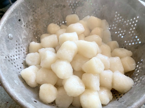 Cook the gnocchi according to package directions and then put into colander.