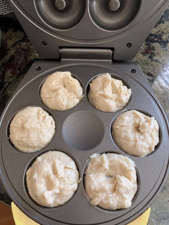 The donut batter in a donut maker.