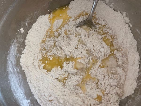 The wet and dry donut ingredients being mixed.