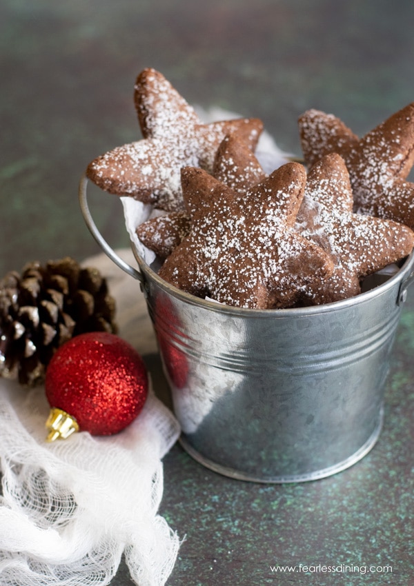 A small silver bucket full of gluten free Swiss brunsli cookies.