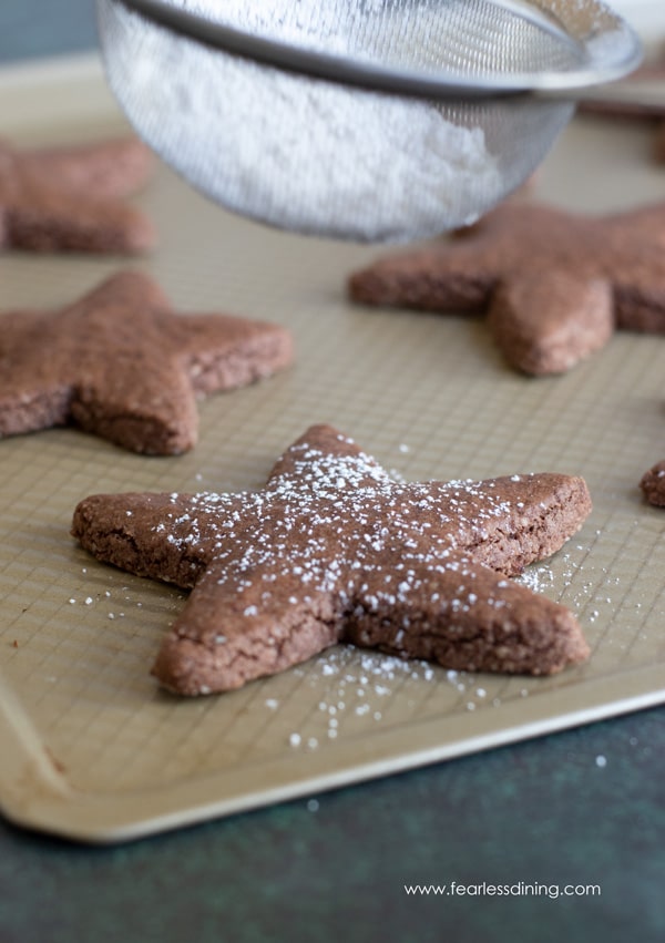 A cookie sheet with chocolate star shaped cookies.