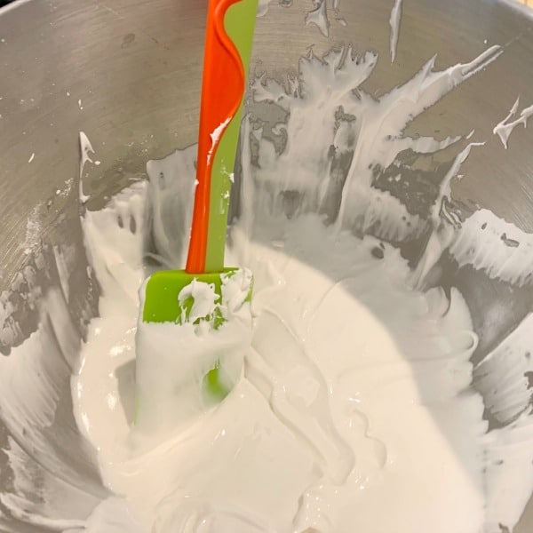 Royal icing in a big silver mixing bowl.