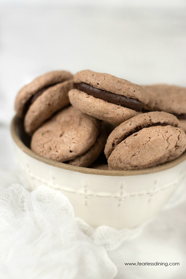 a bowl full of chocolate macarons