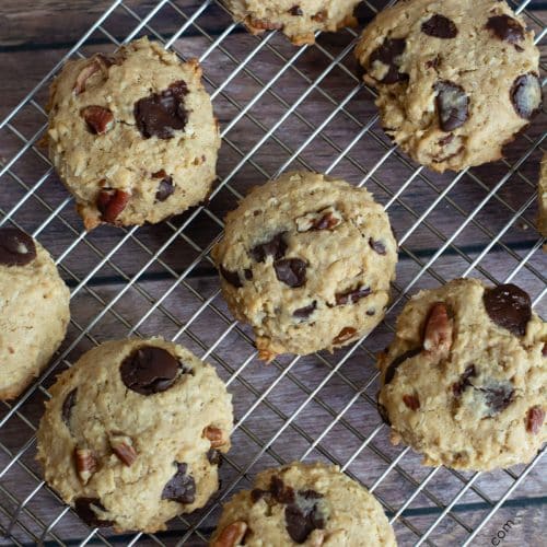 A cooling rack full of baked gluten-free cowboy cookies.
