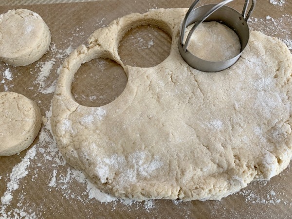 cutting out donut shapes in the dough
