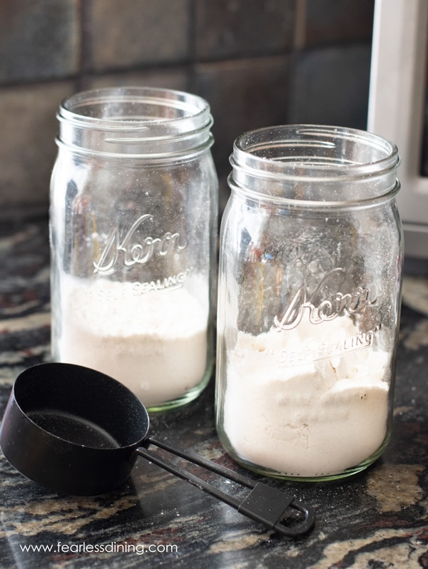 Adding gluten free flour to the mason jars.