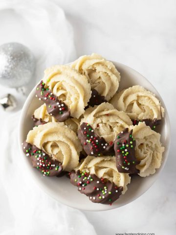 a bowl of decorated butter cookies