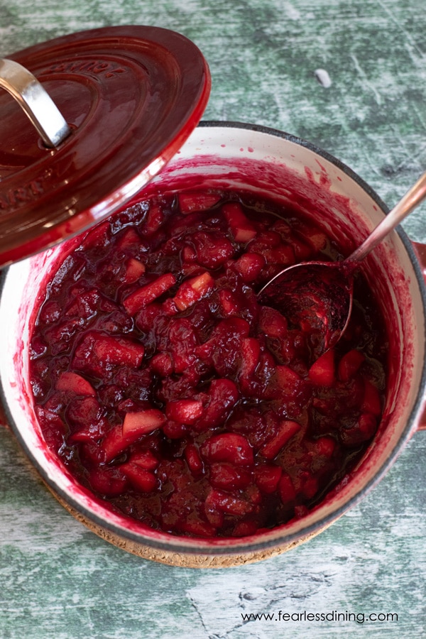 A red pot of homemade cranberry sauce.