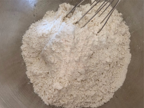 A bowl of the dry ingredients being whisked together.