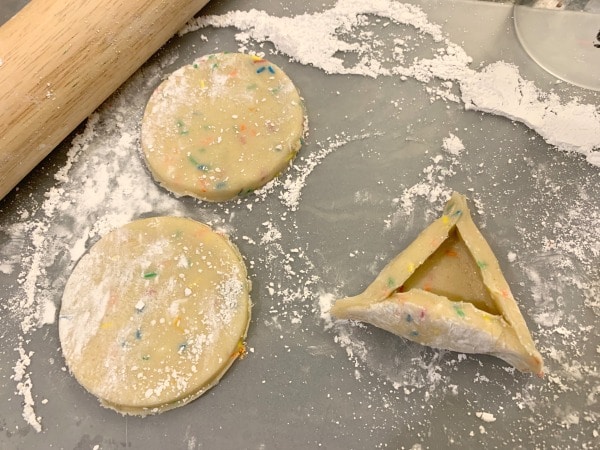 Cutting circles out of the hamantaschen dough.